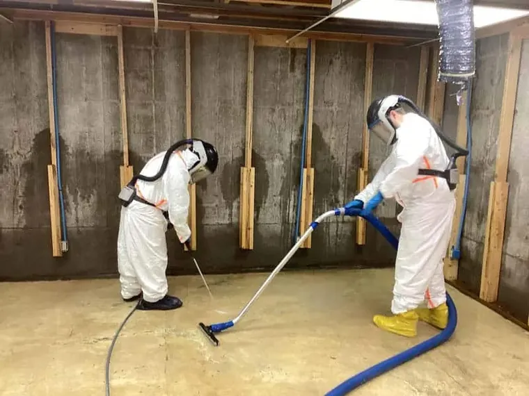 Water Damage Restoration Elkridge technicians extracting water in a basement in Elkridge, MD
